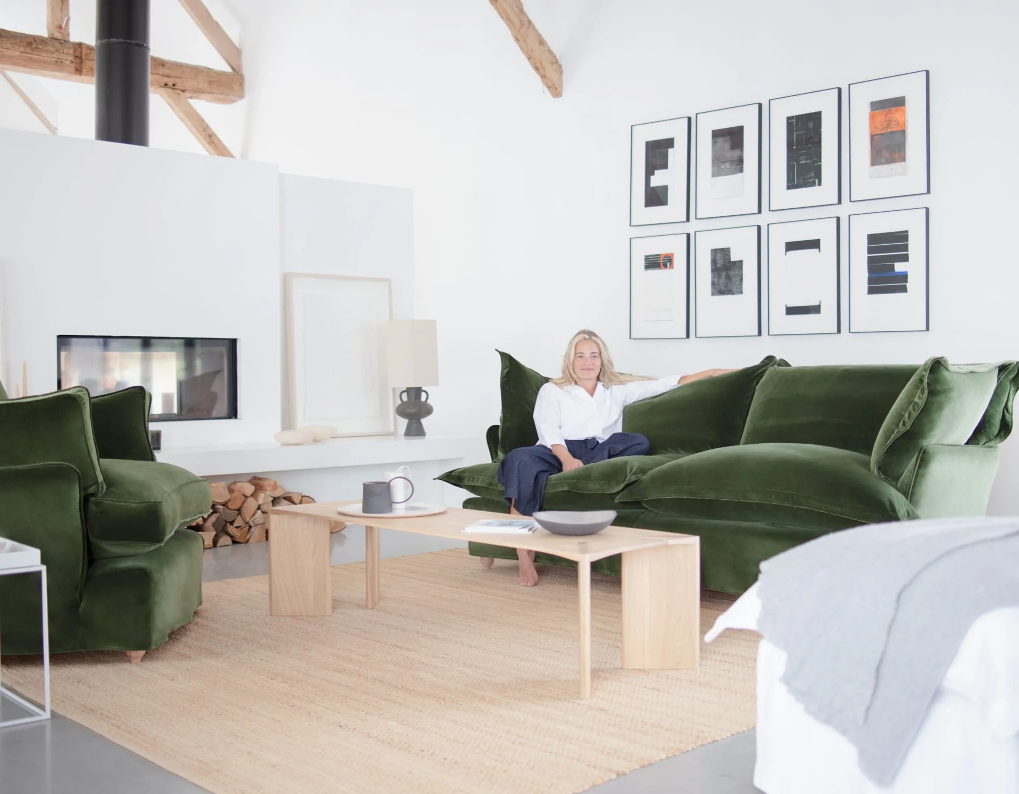 Marnie in a modern room setting featuring Tarragon green velvet Song sofa and Otter box edge Loveseat.